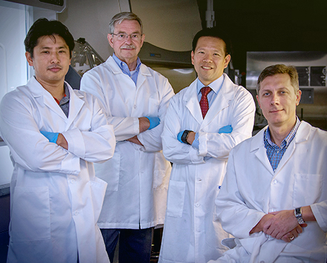 four scientists posed for a photo in the lab